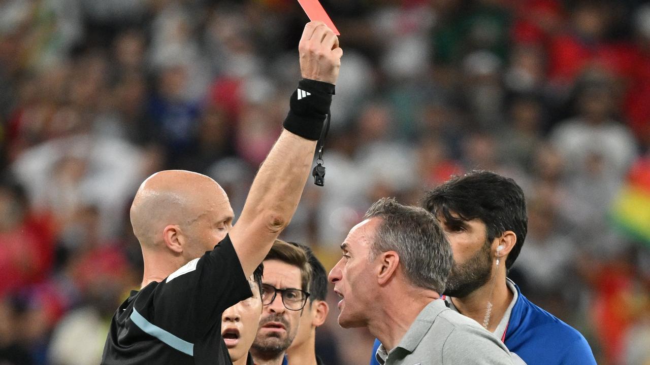 South Korea's Portuguese coach Paulo Bento (R) is given a red card by English referee Anthony Taylor during the Qatar 2022 World Cup Group H football match between South Korea and Ghana at the Education City Stadium in Al-Rayyan, west of Doha, on November 28, 2022. (Photo by JUNG Yeon-je / AFP)