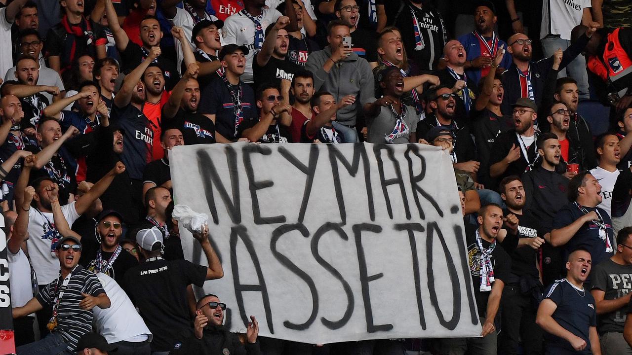 Paris Saint-Germain's supporters hold a banner reading "Neymar, buzz off!" But will he leave? (Photo by FRANCK FIFE / AFP)
