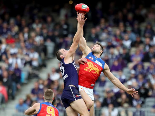 Michael Apeness of the Dockers and Stefan Martin of the Lions contest the ball during the Round 15 AFL match between the Fremantle Dockers and the Brisbane Lions at Optus Stadium in Perth, Sunday, July 1, 2018. (AAP Image/Richard Wainwright) NO ARCHIVING, EDITORIAL USE ONLY