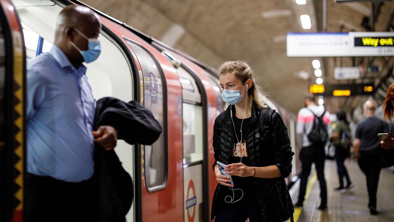 Face coverings such as masks or scarfs are compulsory on public transport, as various stores and outdoor attractions open for the first time in nearly three months. Picture: Tolga AKMEN/AFP.