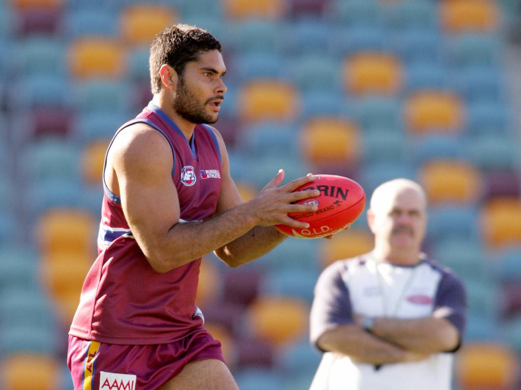 Leigh Matthews keeps a close eye on Michael during a Brisbane training session.