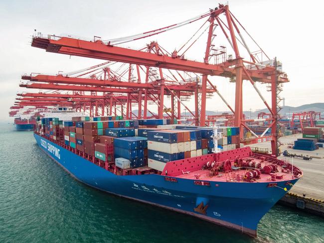 A cargo ship is seen at a port in Qingdao in China's eastern Shandong province on December 8, 2018. - China's export growth slowed last month weighed down by slowing global demand and trade tensions with the United States, official data released on December 8 showed. (Photo by STR / AFP) / China OUT