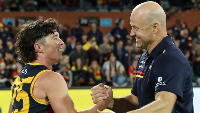 Ned McHenry and Matthew Nicks celebrate Adelaide’s shock win over Melbourne. Picture: Sarah Reed/AFL Photos via Getty Images