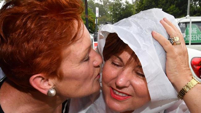 One Nation leader Senator Pauline Hanson (left) and ALP member for Bundamba, Jo-Ann Miller (right) are seen together in the suburb of Bundamba in Ipswich during the Queensland Election campaign on Tuesday, November 21, 2017. Senator Hanson is campaigning in the electorate of Bundamba currently held by the ALP's Jo-Ann Miller. (AAP Image/Darren England) NO ARCHIVING