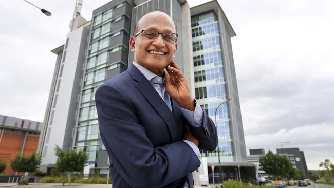 Maha Sinnathamby in front of a building at 145 Sinnathamby Boulevard, Springfield Central, that he bought for $17M. Picture: Sarah Marshall