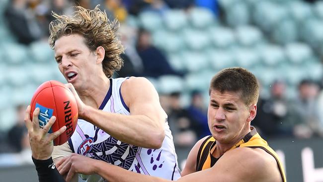 Daniel Howe puts the clamps on Fremantle skipper Nat Fyfe. Picture: AAP