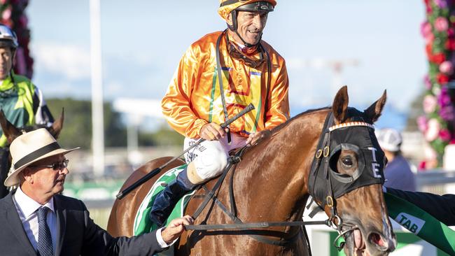 Trainer Toby Edmonds welcomes jockey Robbie Fradd and Tyzone back into the mounting yard after winning the Stradbroke. Picture: AAP