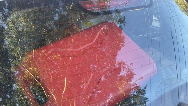 As well as being filled with fast food packaging a red jerry can was spotted in the boot of the white hatchback. Photo: Malcolm Cleary-Polzin