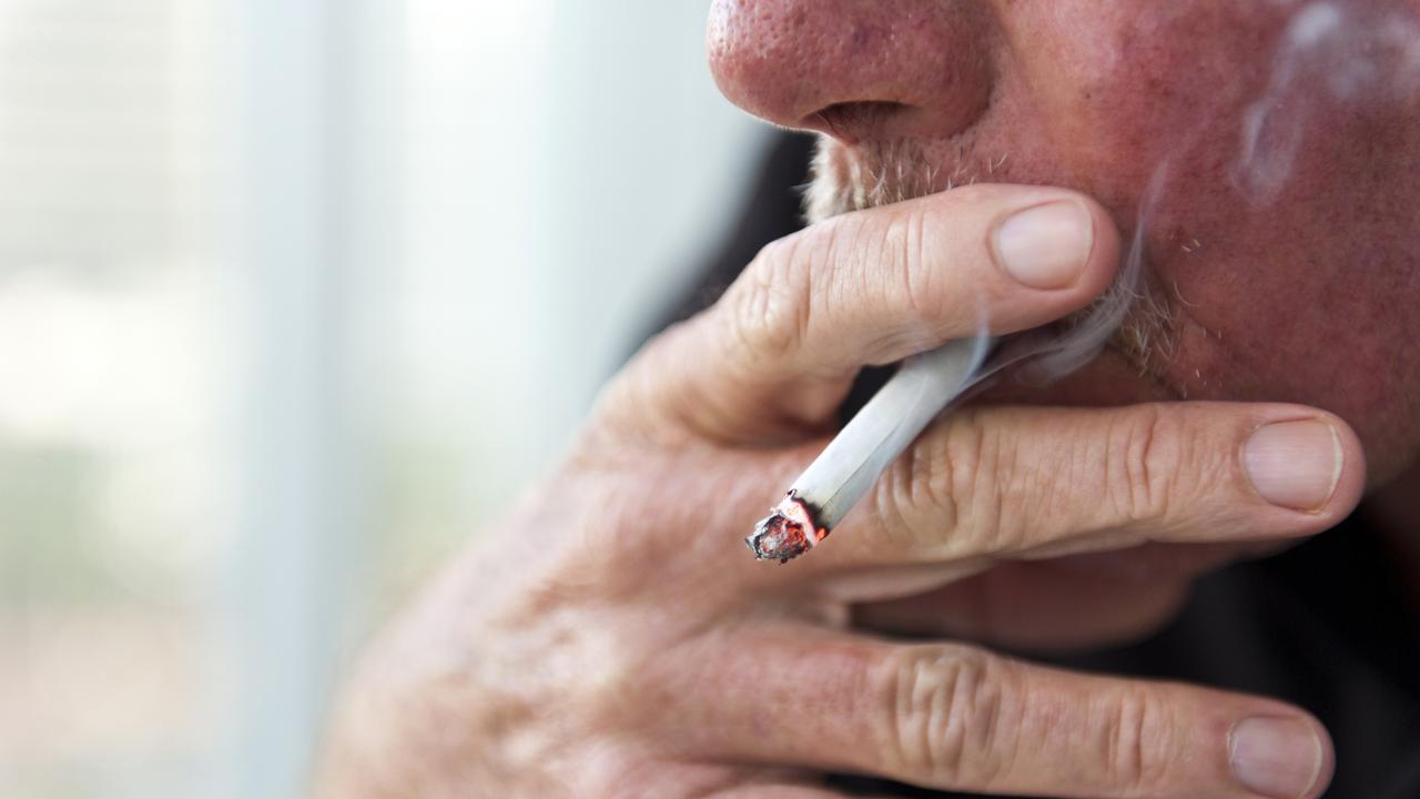 Caucasian old man smoking a cigarette