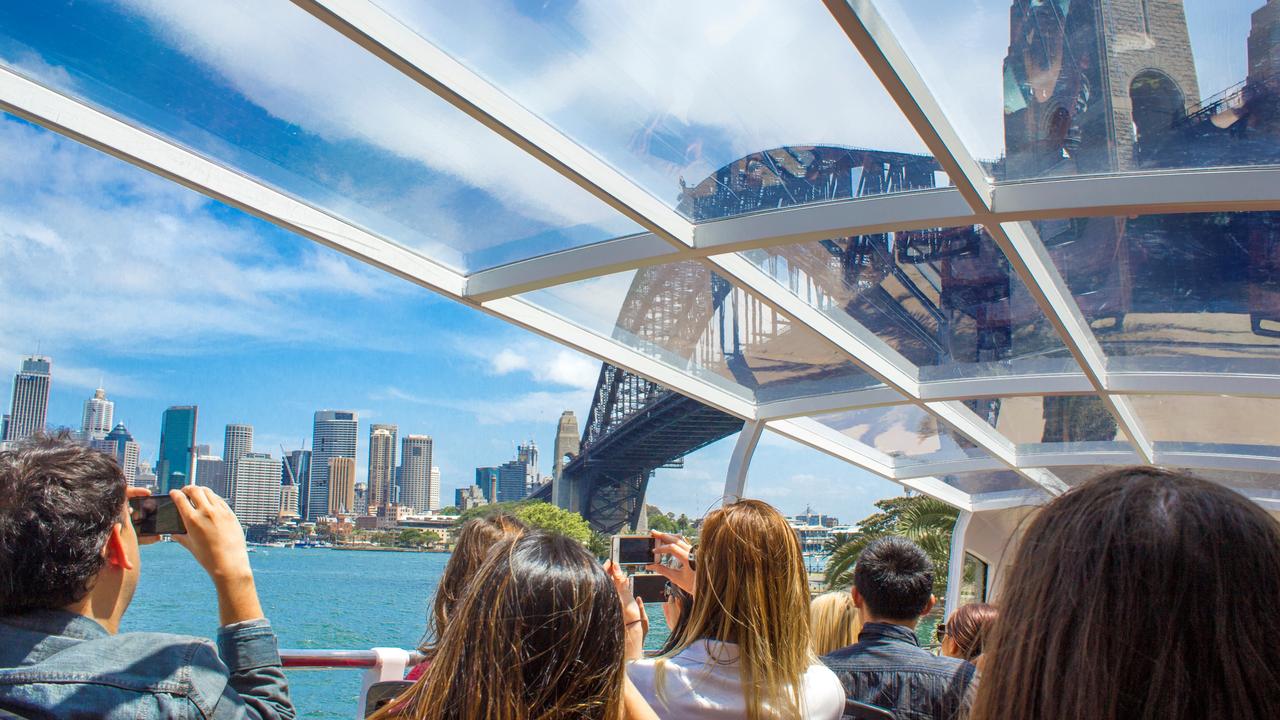 An AAT Kings’ glass roofed bus carries tourists through Sydney.