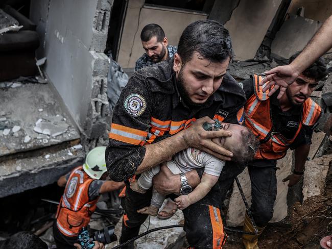 Six-month-old Palestinian baby Sama Alwadia is rescued from under rubble after an Israeli air strike in the Gaza Strip. Picture: Ali Jadallah/Anadolu Agency via Getty Images