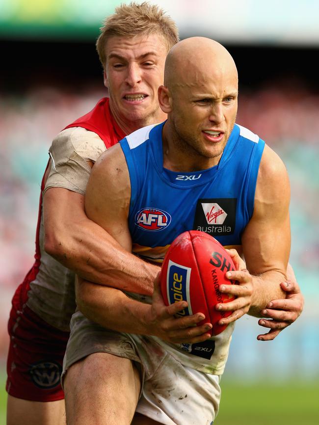 Kieren Jack tackles Gary Ablett.