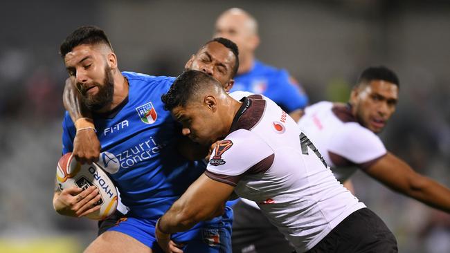 Mason Cerruto of Italy (left) is tackled by Brayden Wiliame of Fiji during the Rugby League World Cup Group D match in 2017.