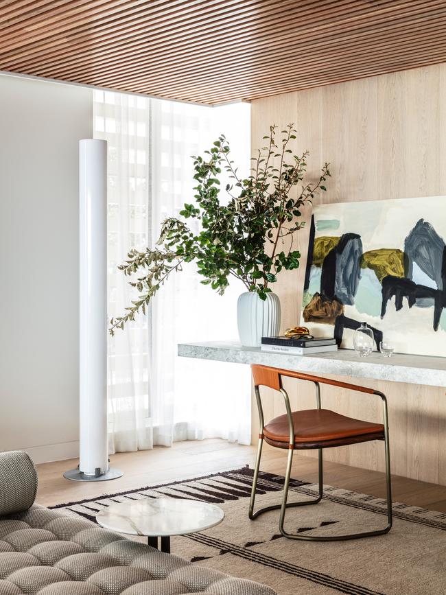 Artwork by Michael Cusack. the blending of elements, such as a Moroccan rug, leather chair, glass floor lamp, timber panelled ceiling and marble benches creates a balance of texture and form.