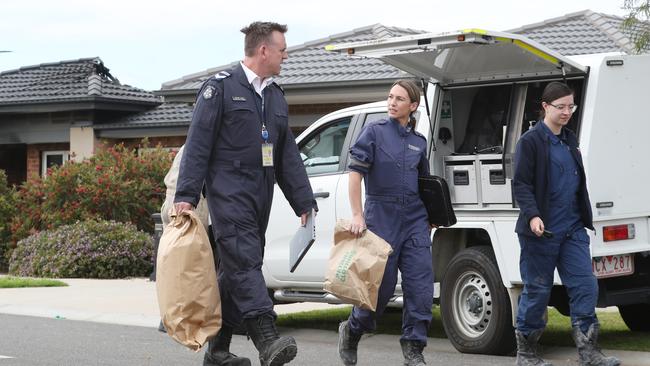 Police remove bags of evidence. Picture: David Crosling