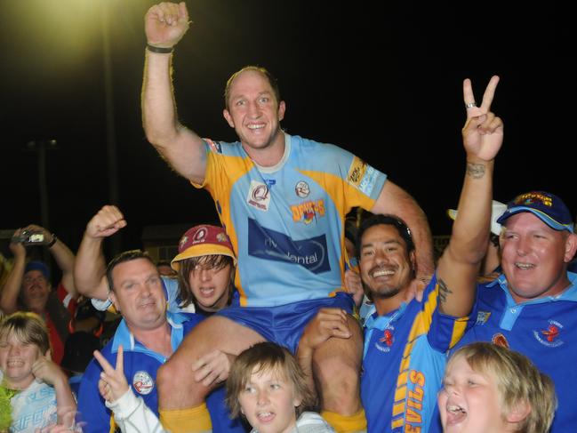 Devils Mal Meninger Medalist Darren Burns gets chaired form the field by Devils supporters after their historic win on Saturday.