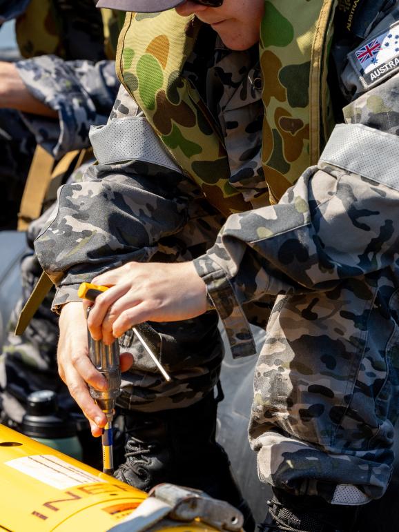 Royal Australian Navy sailor Able Seaman Mary Healy prepares a Bluefin-9 autonomous underwater vehicle for a mission in vicinity HMAS Cairns in support of Exercise Austral Shield 2024. Picture: CPL Michael Currie.