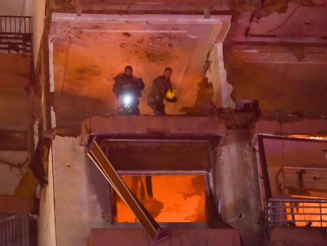 Firefighters search for survivors inside an apartment building hit by an Israeli air strike in Beirut's Cola district, September 30, 2024. Two people were killed in an Israeli strike on Beirut on September 30, a Lebanese security source said, the first strike on the city itself since the October 7 Hamas attack on Israel last year. An Israeli drone targeted an apartment belonging to two members of the Lebanese Islamist group Jamaa Islamiya, said the source. (Photo by Fadel ITANI / AFP)