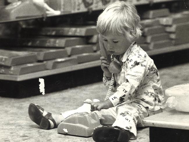 Two-year-old John O'Keeffe of Hawthorn tries to ring Santa on a toy phone in 1975.