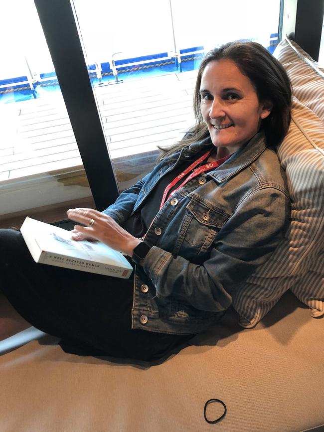 Mercedes Maguire finds a comfy spot to read on a cruise with her family.