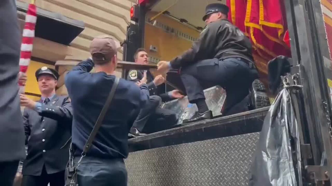 Firefighters Hands Out Flags in Honor of Members Who Died on 9/11