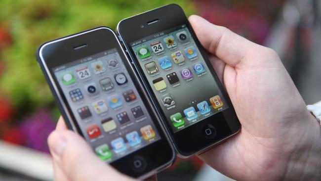 Piotr Kubiak of Oakland, Illinois, shows off his new iPhone 4, right, next to his old iPhone outside of an Apple store / AP