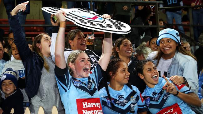 SYDNEY, AUSTRALIA - JUNE 22: Maddison Studdon of the Blues holds the shield as she celebrates victory with the crowd during the Women's State of Origin match between New South Wales and Queensland at North Sydney Oval on June 22, 2018 in Sydney, Australia. (Photo by Mark Kolbe/Getty Images)