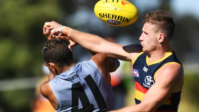 Rory Laird of the Crows and Dom Barry of Power in action.