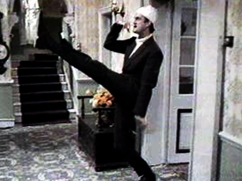 Actor John Cleese as Basil Fawlty doing an impression of Hitler in Fawlty Towers.