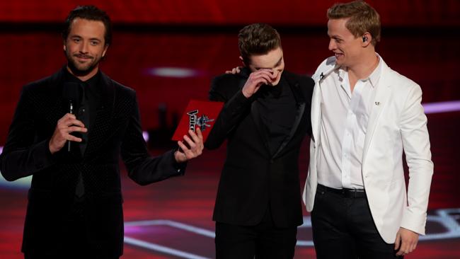 Harrison Craig gets emotional on stage with host Darren McMullen, left, and Luke Kenendy moments before the finals announcement.