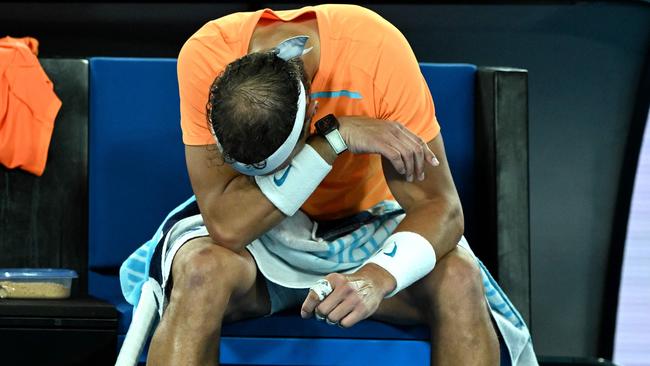 Spain's Rafael Nadal takes rest during the break in his men's singles match against Mackenzie McDonald of the US on day three of the Australian Open tennis tournament in Melbourne on January 18, 2023. (Photo by MANAN VATSYAYANA / AFP)