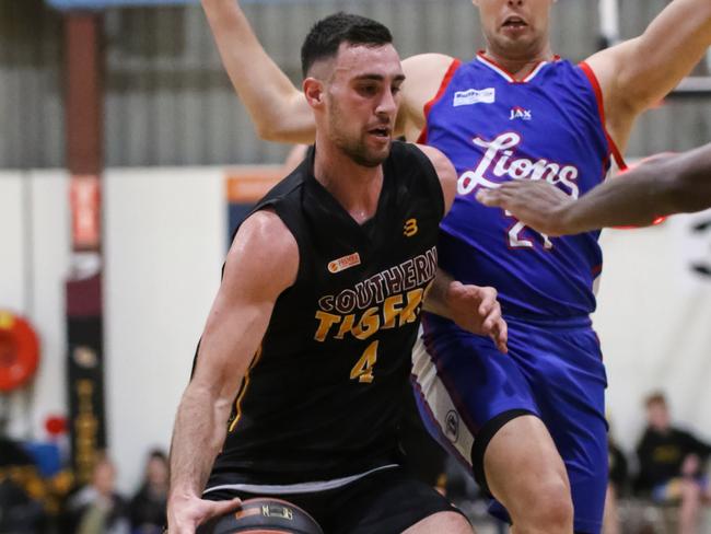 Southern Tigers Sam Johns gets past Central Districts Lions defender Will Twiss Picture: Rod Patterson