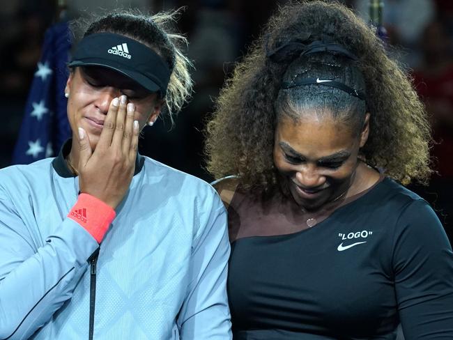 TOPSHOT - US Open Womens Single champion Naomi Osaka of Japan (L) with Serena Williams of the US during their Women's Singles Finals match at the 2018 US Open at the USTA Billie Jean King National Tennis Center in New York on September 8, 2018. (Photo by TIMOTHY A. CLARY / AFP)