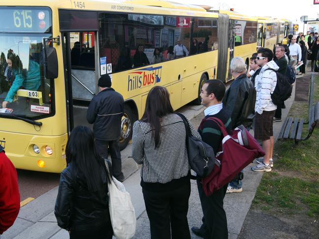 Commuters queue at Baulkham Hills, in northwestern Sydney, to board an overcrowded Castle Hill to Sydney CBD bus service.