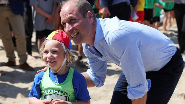 The Prince of Wales speaks with a young member of the Holywell Bay Surf Life Saving Club, during his visit to Fistral Beach in Newquay in Cornwall, South West England on May 9. Picture: AFP