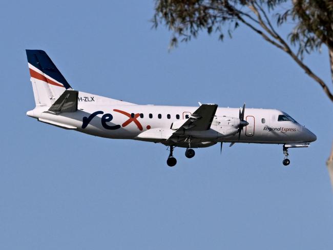 A Rex Airlines Saab 340B prepares to land at Melbourne's Tullamarine Airport on July 30, 2024 after the Australian regional airline announced a trading halt and thus fuelling speculations of financial challenges. (Photo by William WEST / AFP)