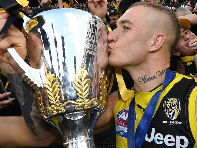 Dustin Martin kisses the AFL premiership trophy after winning the AFL grand final between the Adelaide Crows and Richmond Tigers at the MCG in Melbourne, Saturday, September 30, 2017. (AAP Image/Julian Smith) NO ARCHIVING