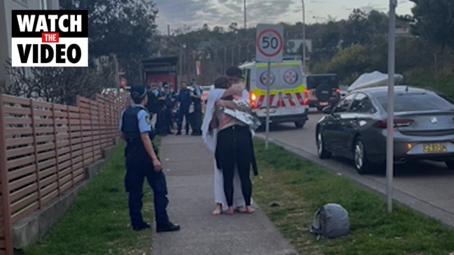 Friends embrace after North Bondi spearfishing incident