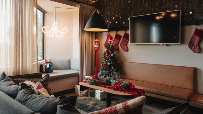 The rooms come with large red and green velvet curtains, Christmas-themed quilt covers, stockings and of course, a Christmas tree. Picture: Supplied.