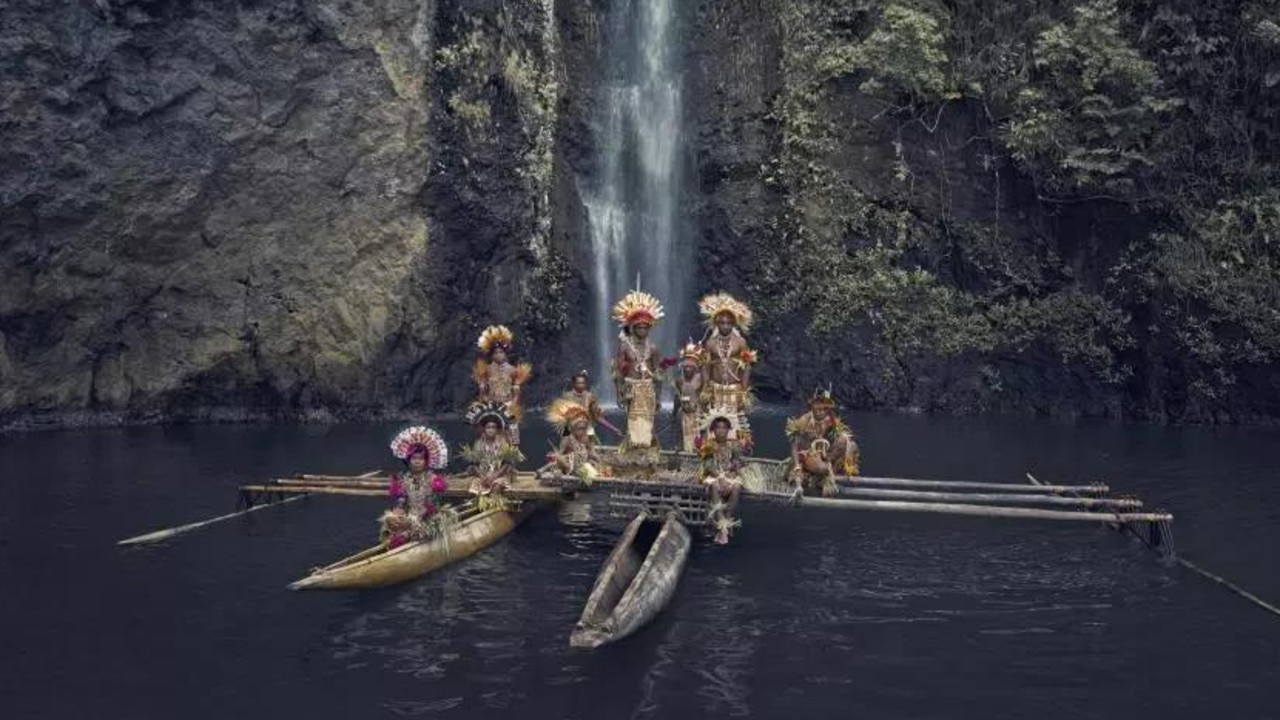 The Tufi tribe in New Guinea on their fishing boat. Picture: Jimmy Nelson
