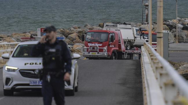 One of the cars found in the water at West Beach boat ramp is taken away by a tow truck. Picture: NCA NewsWire / Roy VanDerVegt