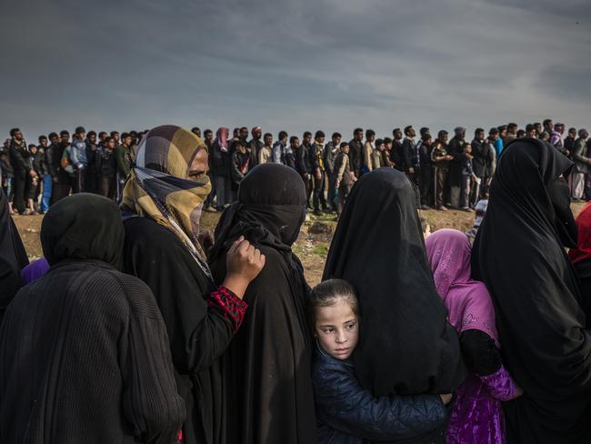 Civilians who had remained in west Mosul during the battle to retake the city, lined up for an aid distribution in the Mamun neighbourhood. After months of being trapped in the last remaining ISIS held areas of the city the people in west Mosul were severely short on food and water. Picture: Ivor Prickett for the New York Times/World Press PHoto