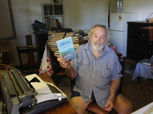 Author Richie Britton holds up the second edition of his book Around the Cassowary Rock. Picture: Peter Carruthers