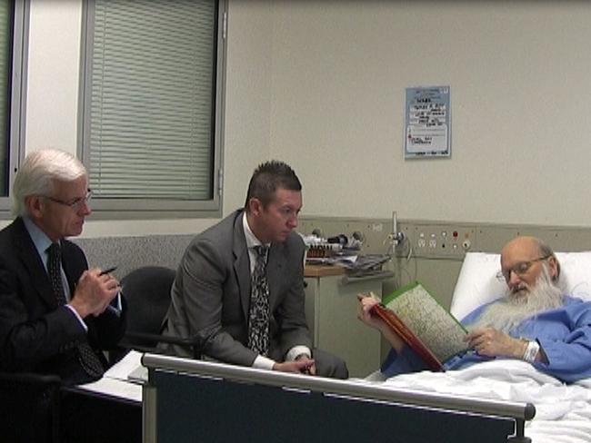 Deputy State Coroner Iain West (left) and Detective Senior Sergeant Wayne Newton hold vigil by the bedside of suspected child serial killer Derek Percy in 2013. Picture: NewsCorp