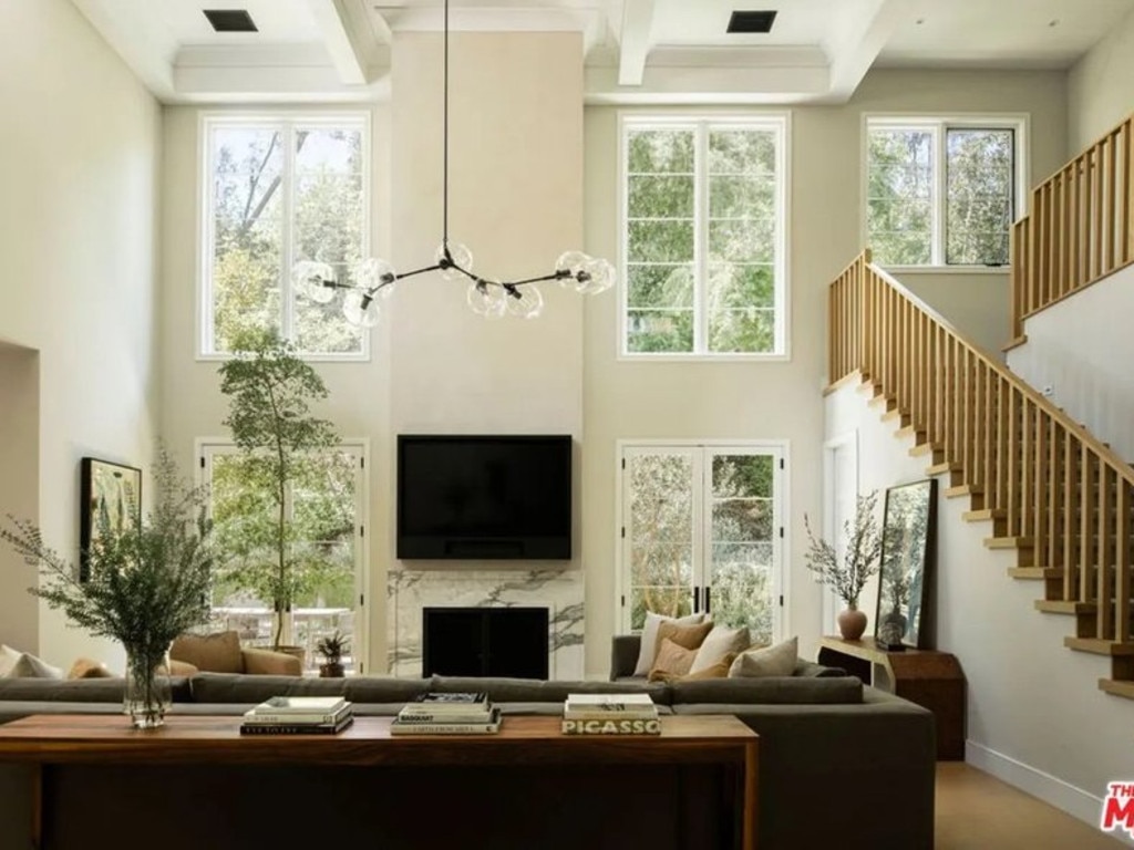 The main living area with soaring ceilings and staircase that leads to the second floor. Picture: Realtor.com