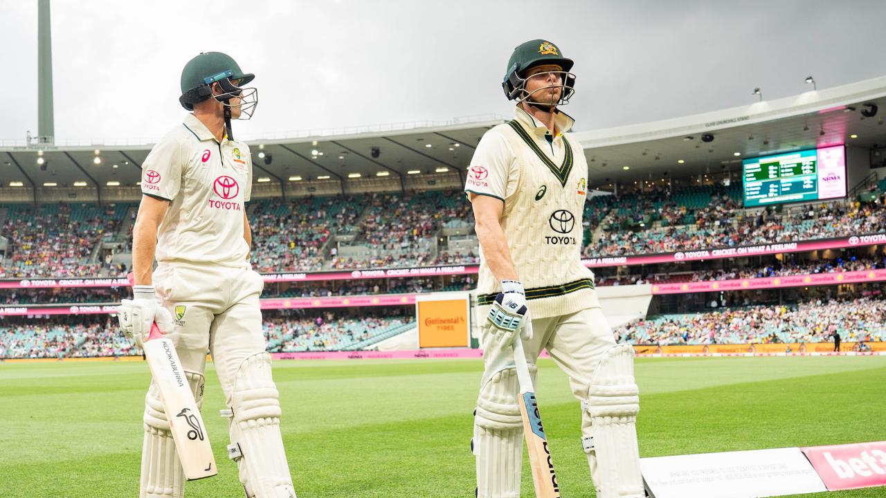 Marnus Labuschagne and Steve Smith walk off the SCG due to bad light. Photo: Tom Parrish