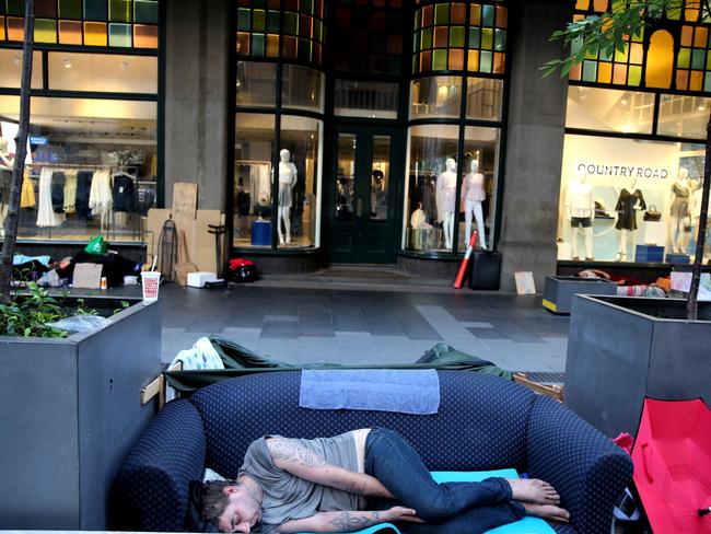 Jack Leafe asleep on his couch on Tuesday outside the QVB on George St Sydney. Picture: John Grainger