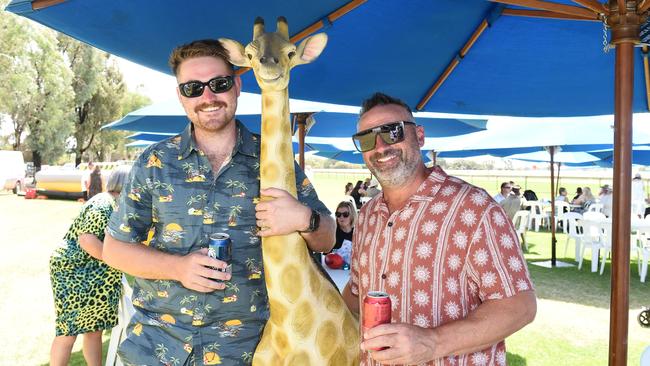 Liam O’Halloran, Henry the Giraffe and Luke Politino at Moama Bowling Club Echuca Cup. Picture: David Smith