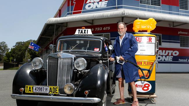 Murwillumbah 'collector' and car dealer Phil Taylor with his latest 'rpide and joy', an old Golden Fleece fuel bowser on display at Auto One. Photo" RICHARD MAMANDO