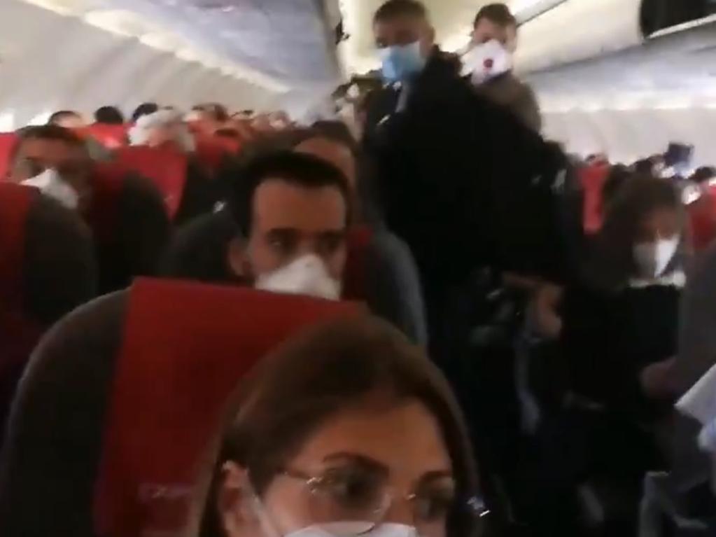 The video shows passengers seated close together on the flight.